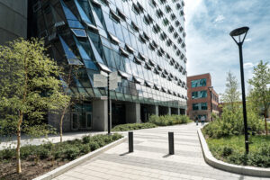 MacKimmie Complex at the University of Calgary in Calgary, Alberta. Completed in 2022 and designed by DIALOG, the redevelopment transformed the former MacKimmie Tower and Block into a 33,000-square-metre high-performance academic and administrative complex. The project achieved LEED Platinum certification and Canada Green Building Council Zero Carbon Building certification, using a dynamic double-skin façade with automated windows and shades, passive ventilation, thermal mass, heat recovery, solar exposure and on-site solar PV.. With 80% less energy than the former MacKimmie, more than 600 MWh/year of solar generation, and 2,800 tonnes of avoided CO₂ from reusing the existing tower structure. MacKimmie Building - University of Calgary
